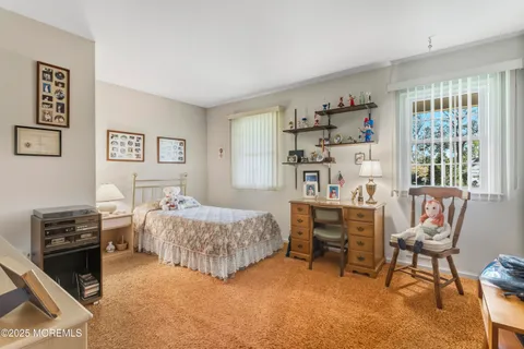 a bedroom that has a bed and a chair in it