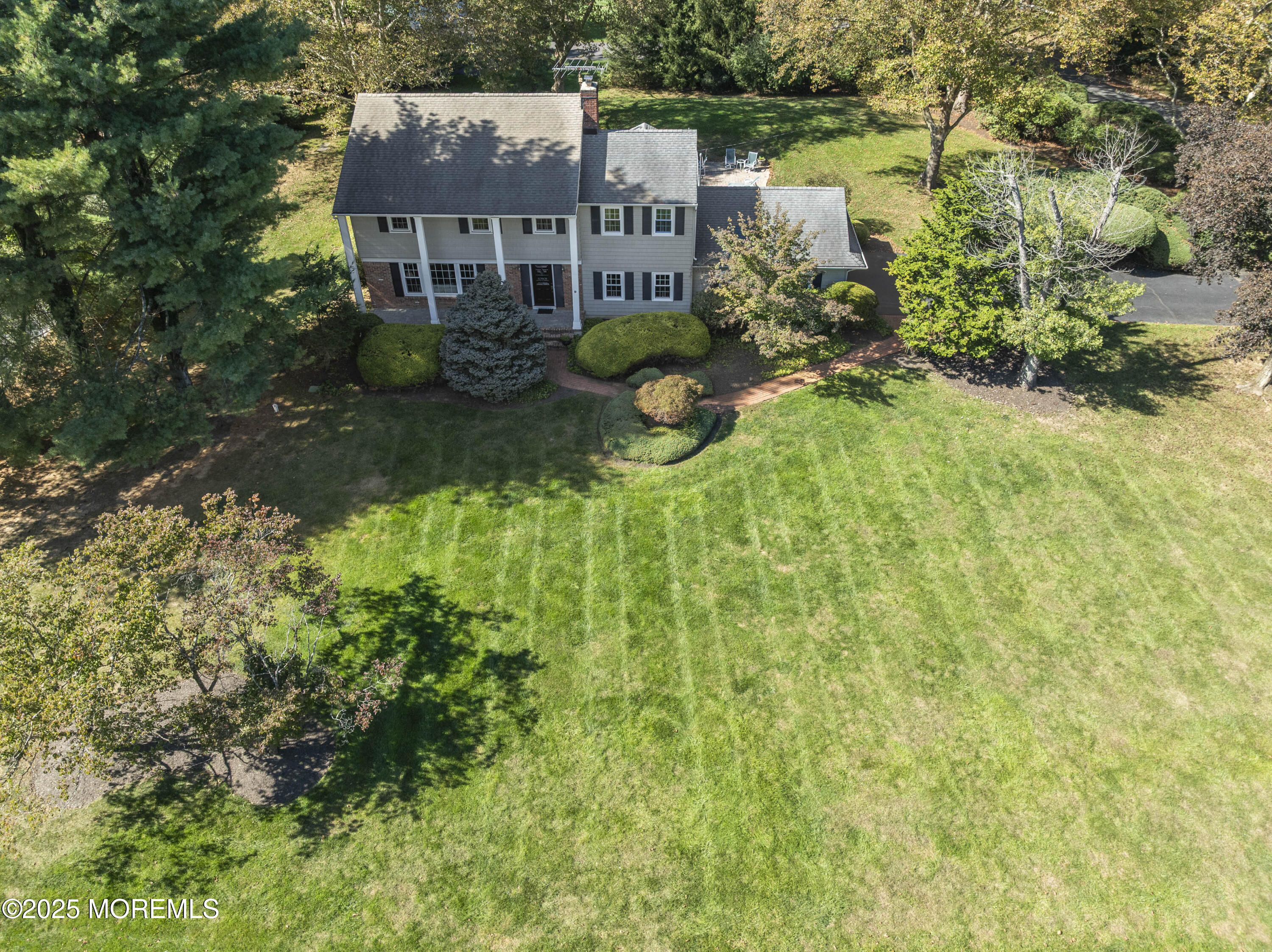 9 Mulberry Lane Colts Neck, NJ 07722 - Photo 27 of 36 an aerial view of a house with a yard and large trees