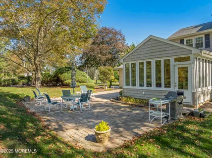 a view of a house with backyard and sitting area