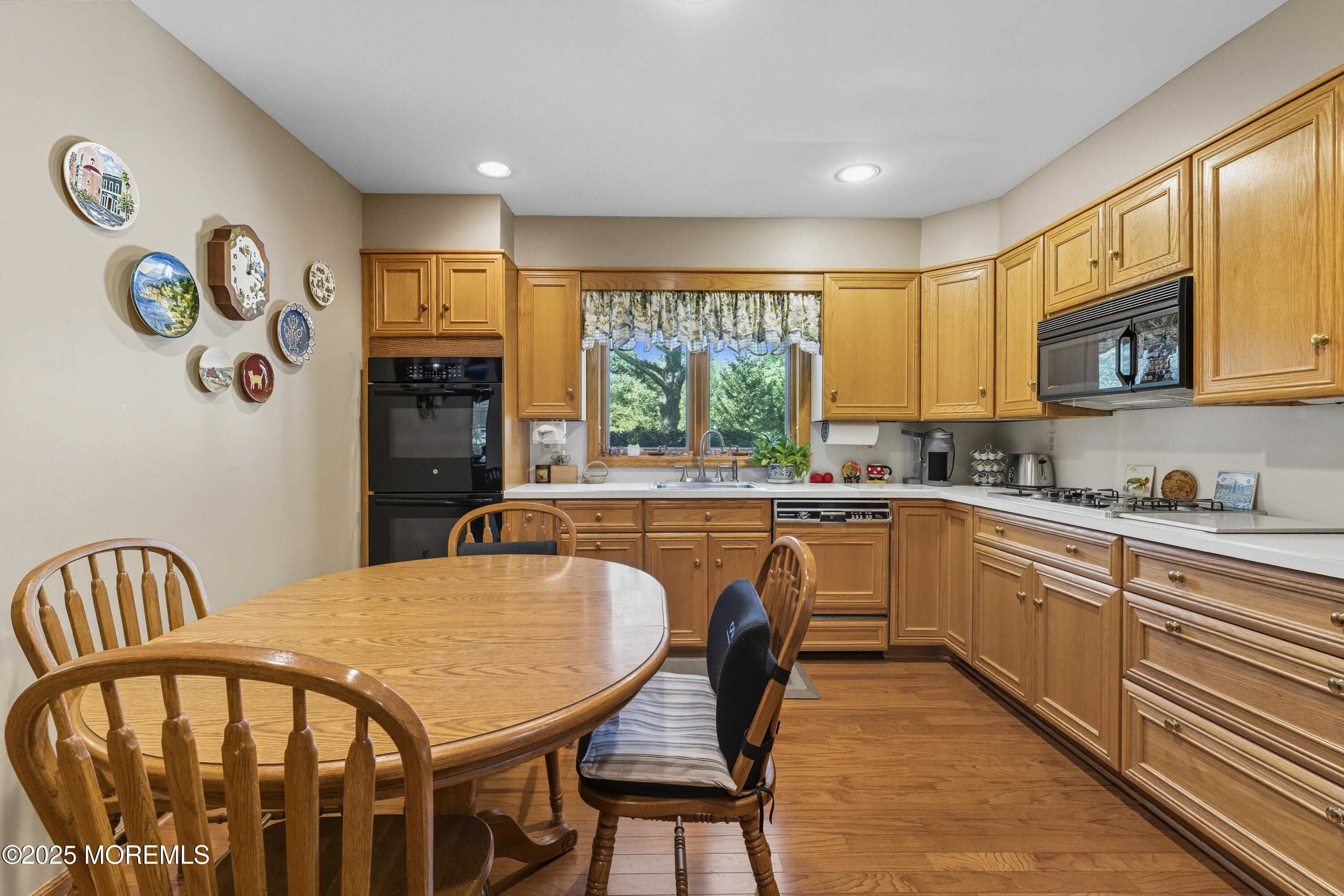 9 Mulberry Lane Colts Neck, NJ 07722 - Photo 8 of 36 a kitchen with stainless steel appliances granite countertop a stove a sink a refrigerator dining table and chairs with wooden floor