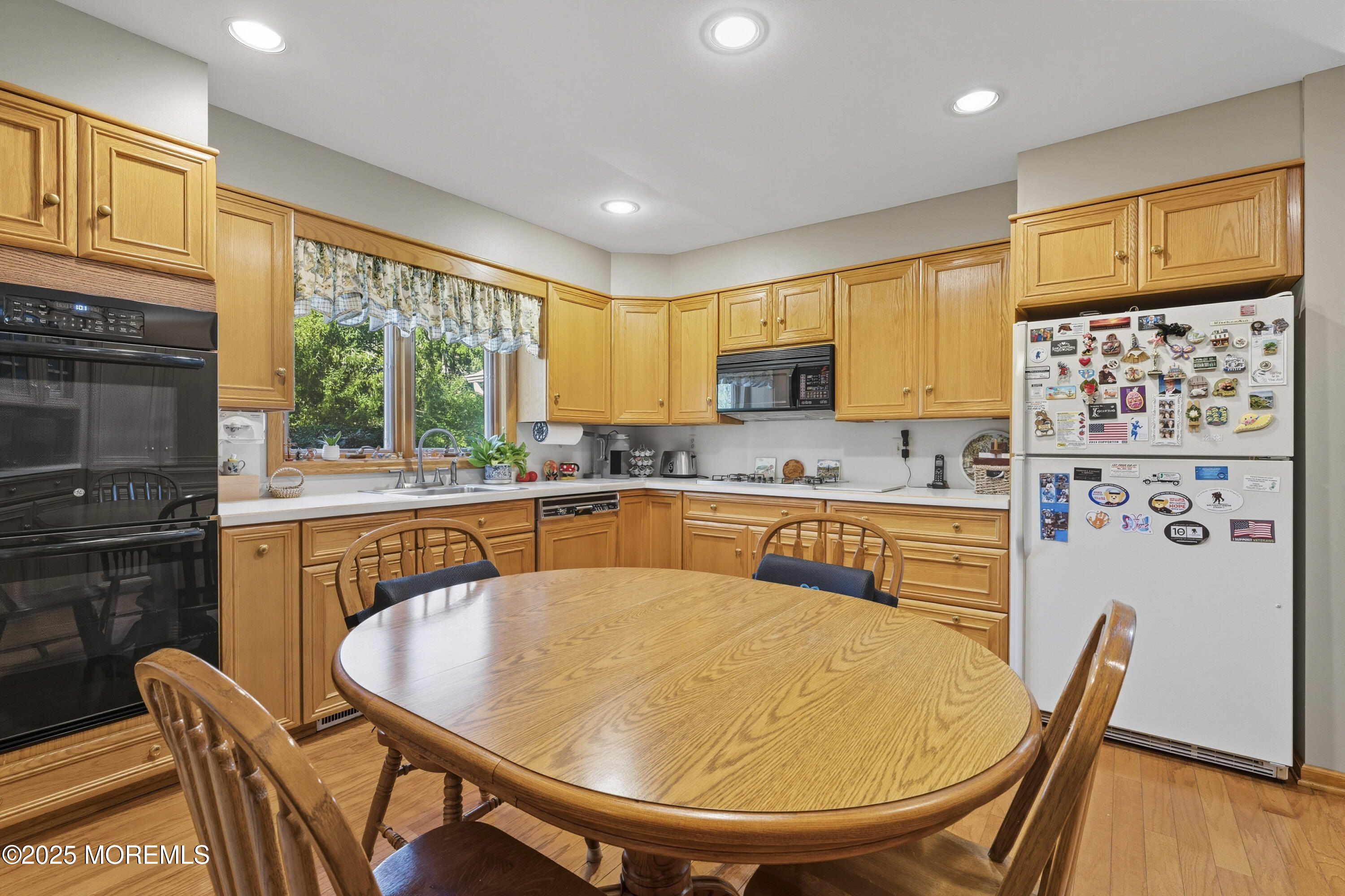 9 Mulberry Lane Colts Neck, NJ 07722 - Photo 9 of 36 a kitchen with stainless steel appliances granite countertop a stove a sink a dining table and chairs