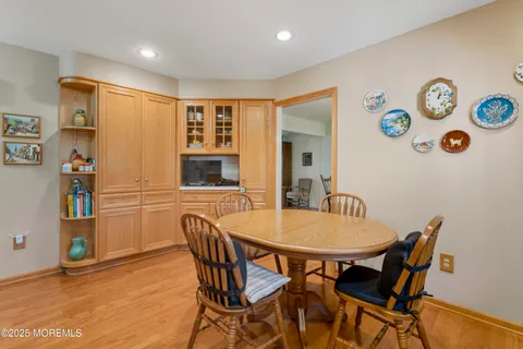 a view of a dining room with furniture and a kitchen