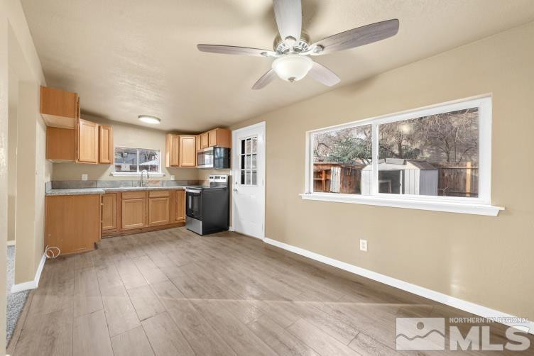 565 Colorado River Boulevard Reno, NV 89502 - Photo 16 of 25 a kitchen with stainless steel appliances granite countertop a stove cabinets and wooden floor