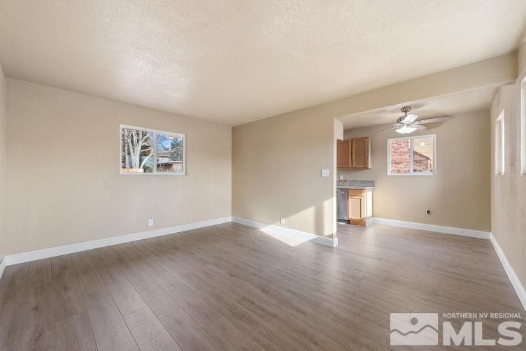 565 Colorado River Boulevard Reno, NV 89502 - Photo 3 of 25 a view of an empty room with wooden floor and a window