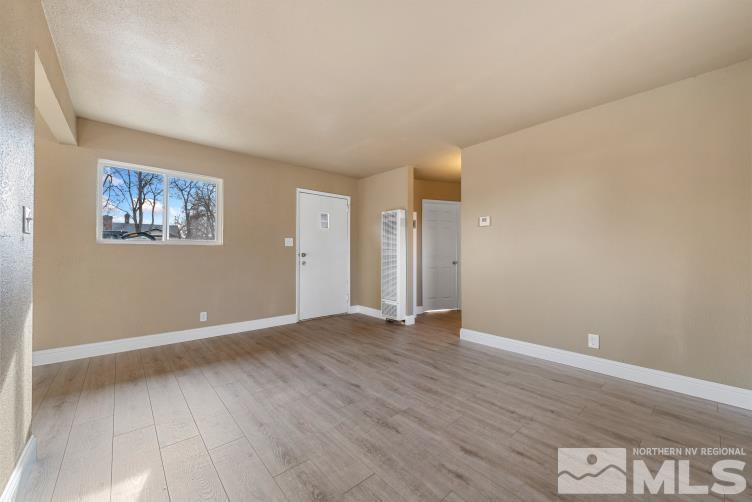565 Colorado River Boulevard Reno, NV 89502 - Photo 4 of 25 a view of an empty room with wooden floor