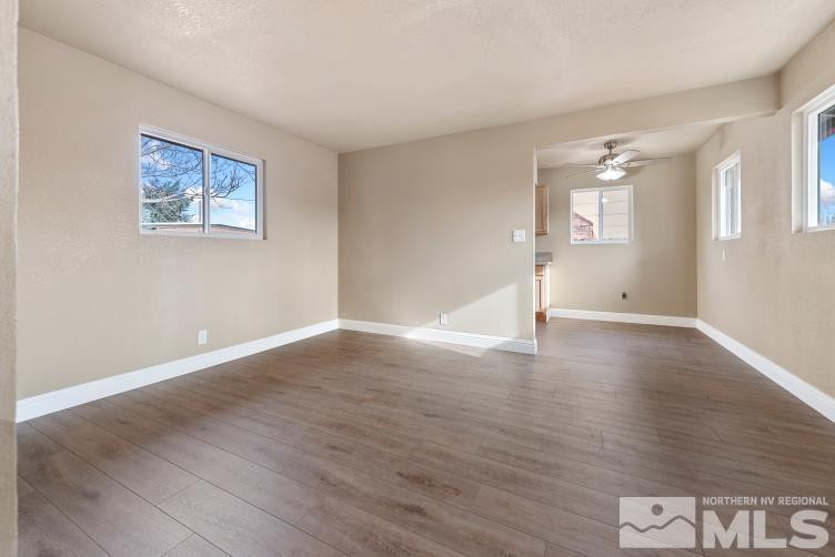 565 Colorado River Boulevard Reno, NV 89502 - Photo 5 of 25 a view of an empty room with wooden floor and a window