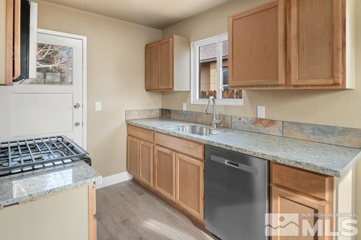 565 Colorado River Boulevard Reno, NV 89502 - Photo 7 of 25 a kitchen with stainless steel appliances granite countertop a sink stove and cabinets