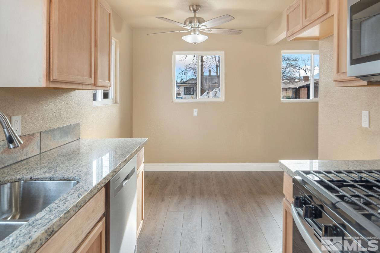 565 Colorado River Boulevard Reno, NV 89502 - Photo 8 of 25 a kitchen with granite countertop a stove and a sink