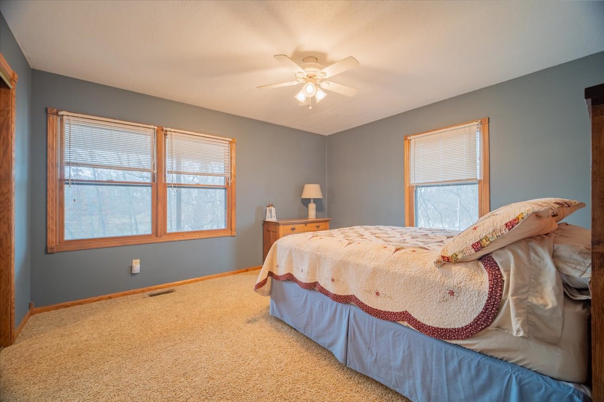 11000 Pear Tree Road Dewitt, IL 61735 - Photo 25 of 30 a bed sitting in a bedroom next to a window