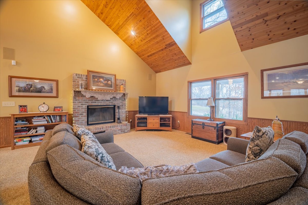 11000 Pear Tree Road Dewitt, IL 61735 - Photo 4 of 30 a large bedroom with furniture fireplace and a flat screen tv