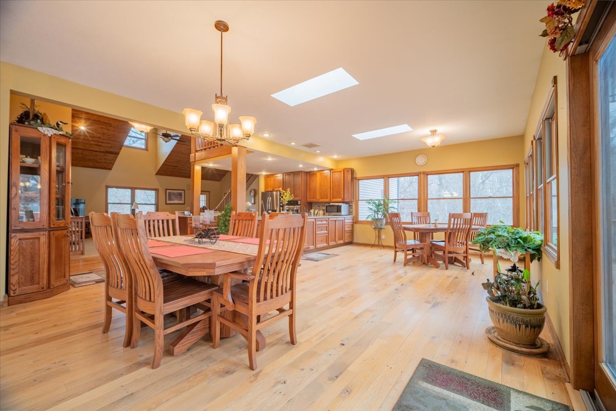 11000 Pear Tree Road Dewitt, IL 61735 - Photo 7 of 30 a view of a dining room and livingroom with furniture wooden floor a chandelier