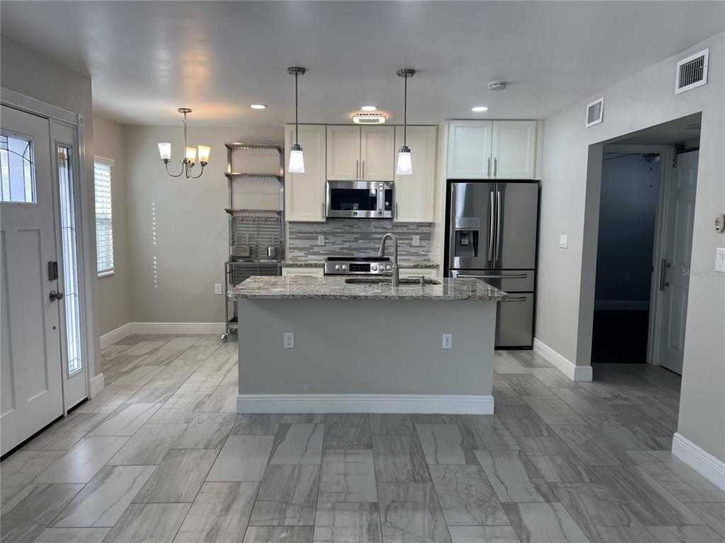 1742 8th Street Sarasota, FL 34236 - Photo 3 of 19 a kitchen with stainless steel appliances granite countertop a refrigerator a sink a stove and a oven