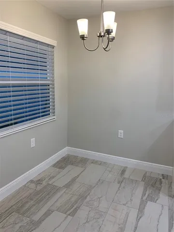 a bathroom with a light fixture and a window