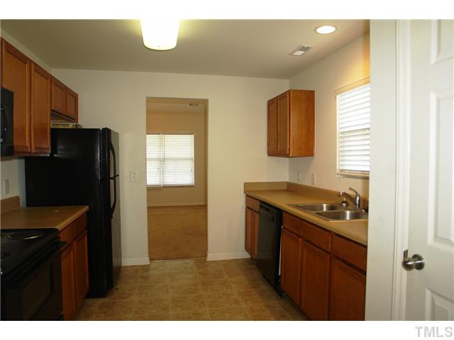 1508 Ricochet Drive Raleigh, NC 27610 - Photo 4 of 8 a kitchen with a refrigerator and a sink