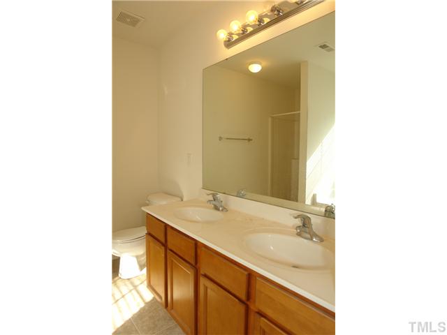 1508 Ricochet Drive Raleigh, NC 27610 - Photo 7 of 8 a bathroom with a sink and a mirror