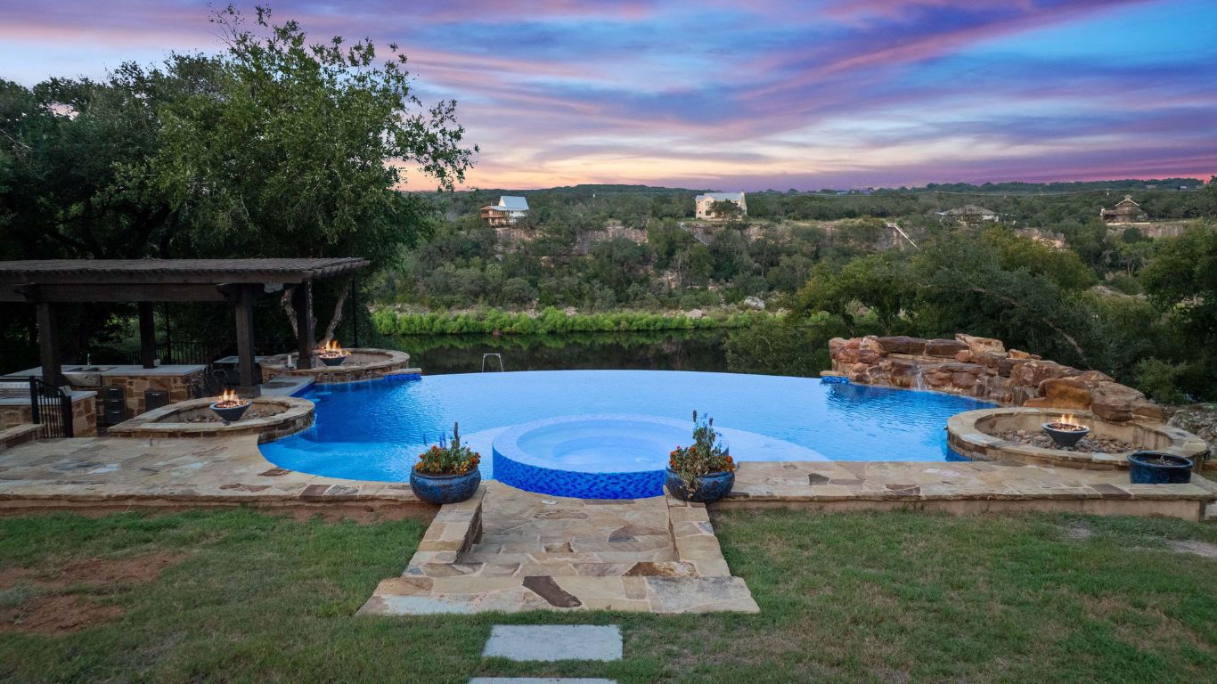 Stunning infinity edge pool with gorgeous water views! Three fire pits and a swim up bar -perfect for entertaining!