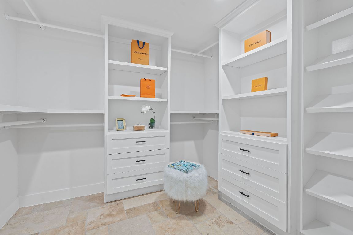 1325 Likeness Road Spicewood, TX 78669 - Photo 14 of 38 Spacious closet with stone tile flooring and custom built-ins