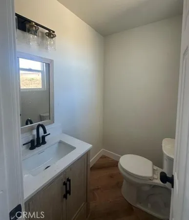 a bathroom with a toilet a sink and mirror