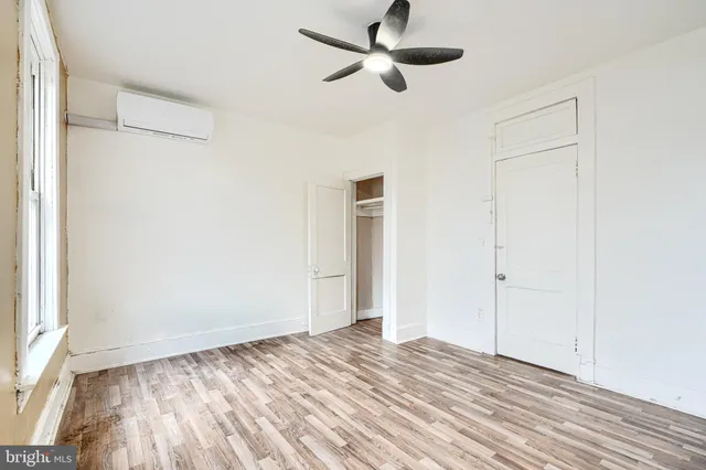 a view of empty room with wooden floor