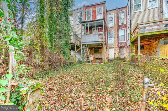 a front view of a residential apartment building with a yard
