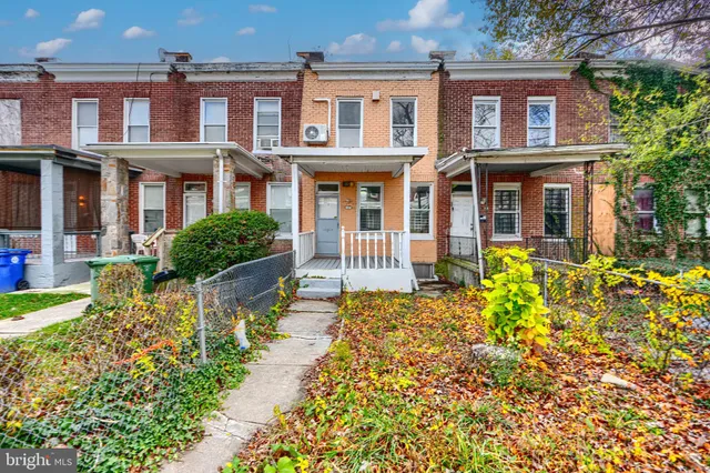 front view of a brick house with a yard
