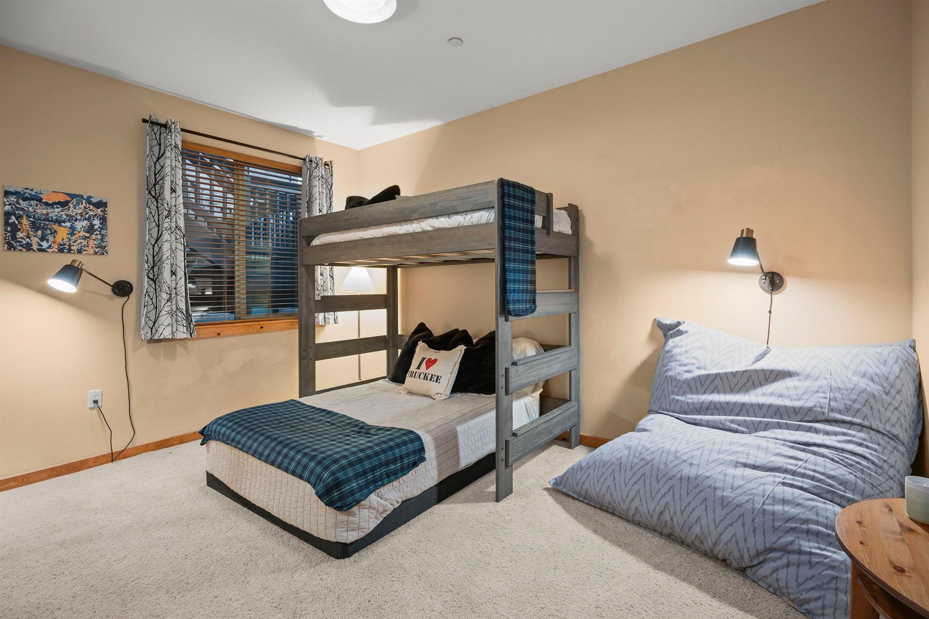 11420 Dolomite Way, Unit 1 Truckee, CA 96161 - Photo 17 of 28 a bedroom with a bed lamp and large window