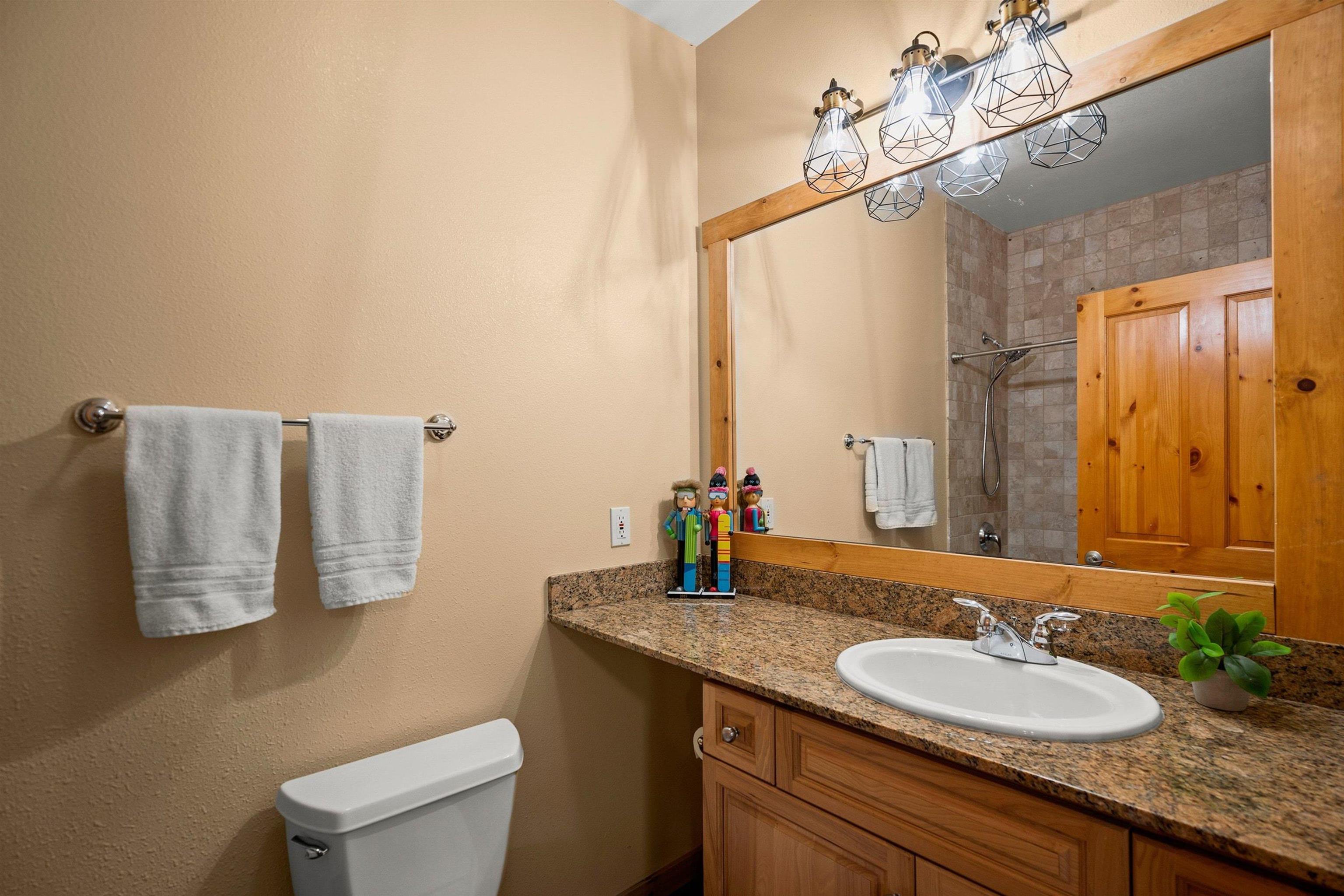 11420 Dolomite Way, Unit 1 Truckee, CA 96161 - Photo 18 of 28 a bathroom with a granite countertop sink and a mirror