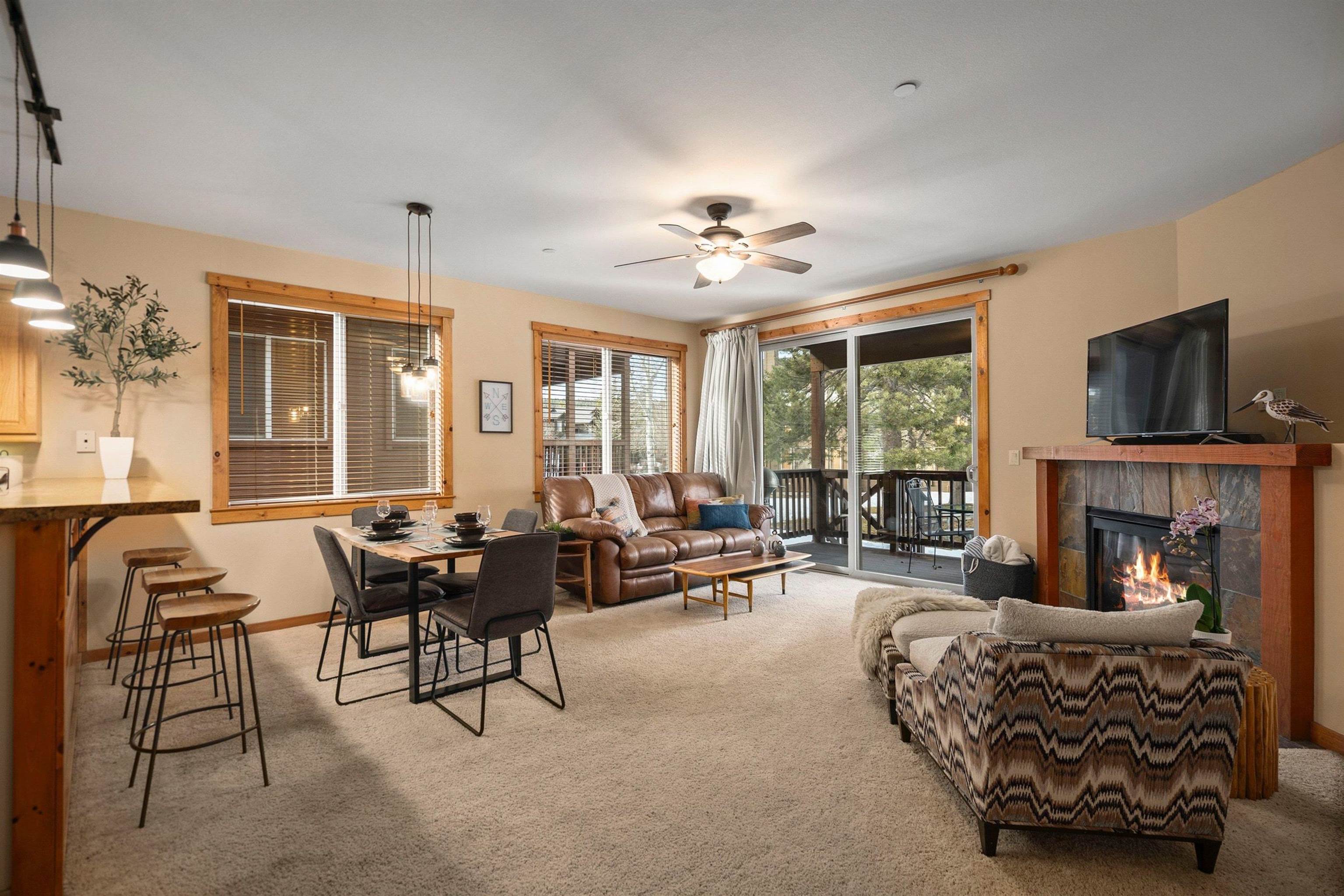 11420 Dolomite Way, Unit 1 Truckee, CA 96161 - Photo 2 of 28 a living room with furniture a fireplace and a large window
