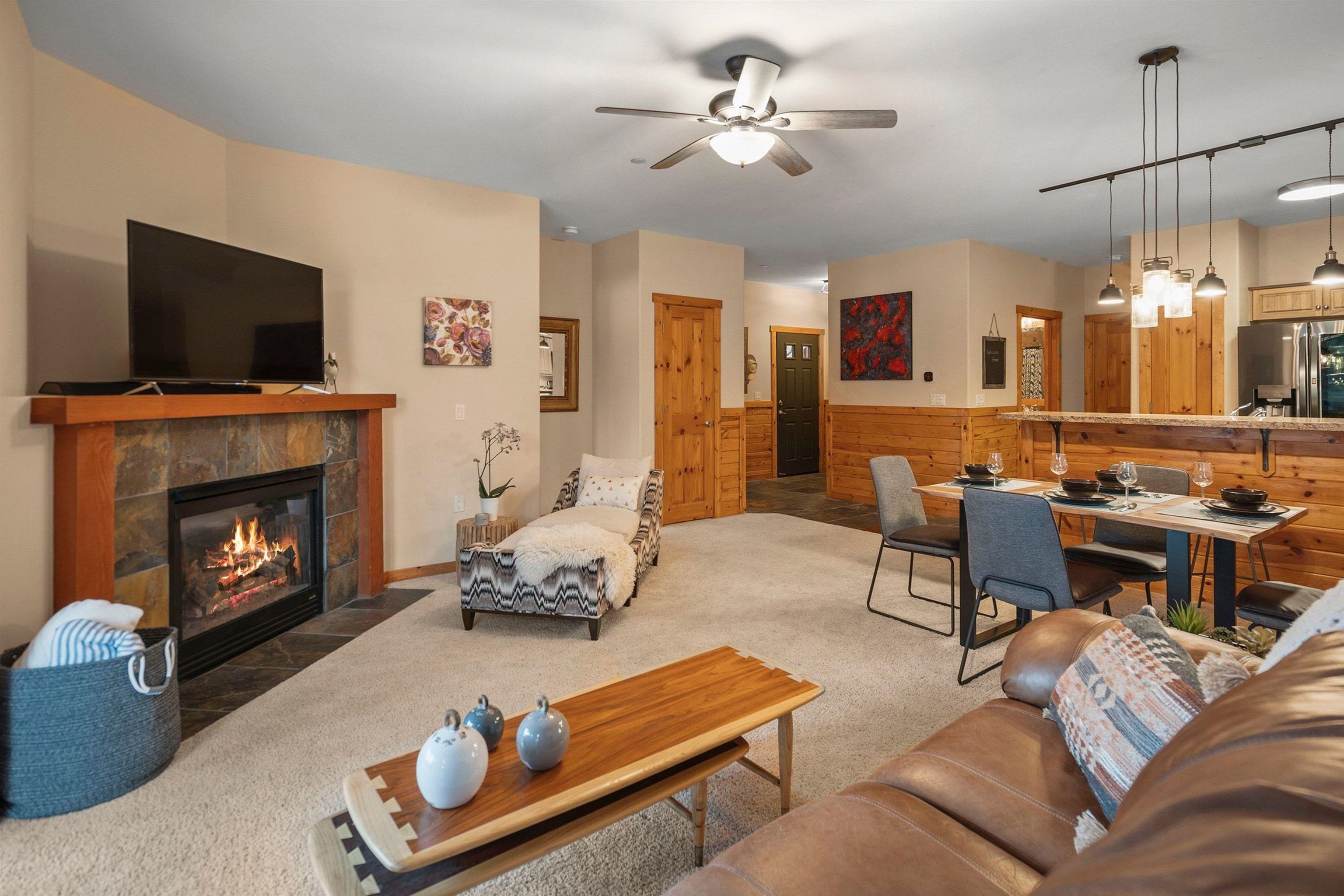 11420 Dolomite Way, Unit 1 Truckee, CA 96161 - Photo 6 of 28 a living room with furniture a flat screen tv and a fireplace