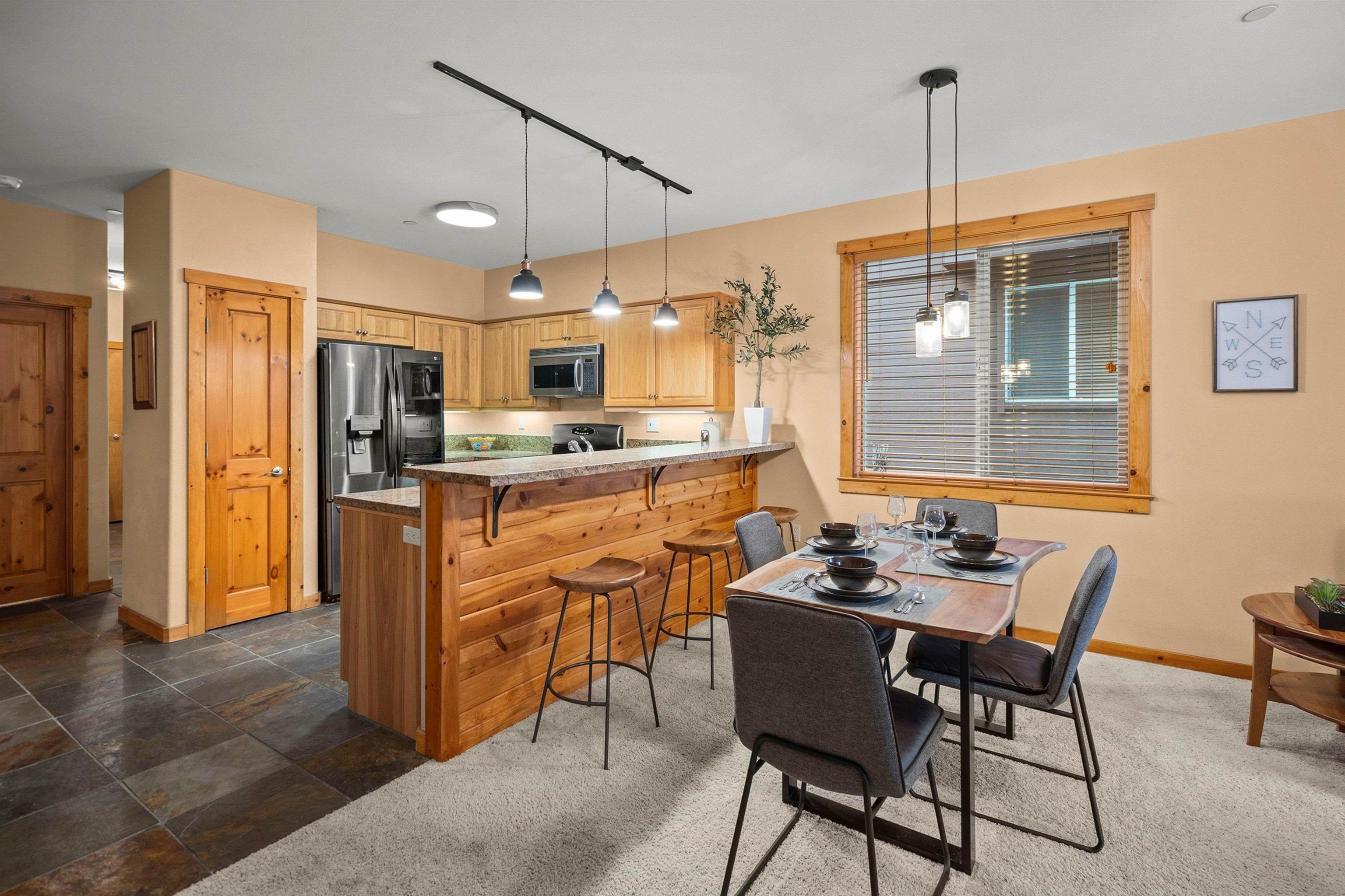 11420 Dolomite Way, Unit 1 Truckee, CA 96161 - Photo 7 of 28 a dining room with stainless steel appliances kitchen island granite countertop furniture and a kitchen view