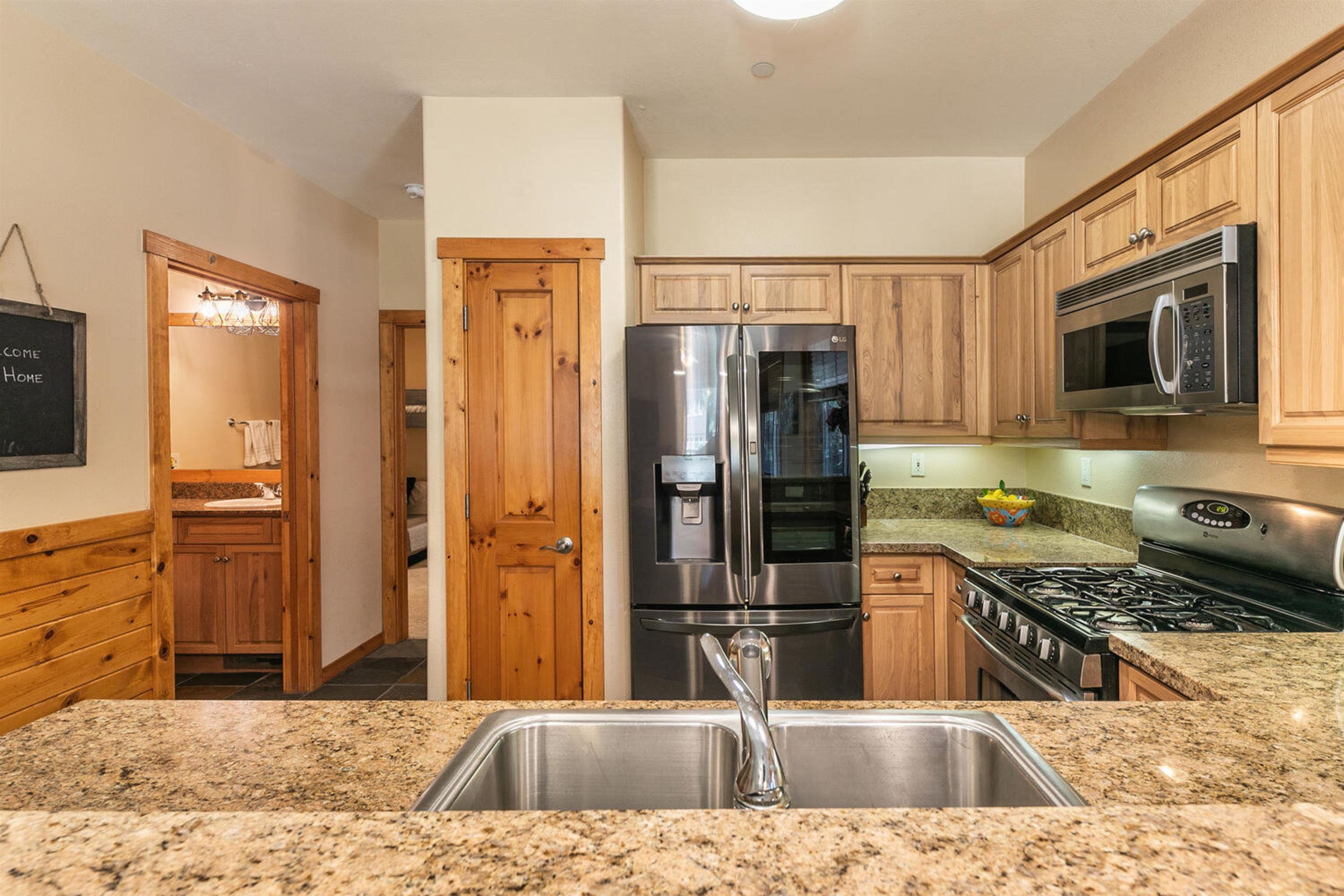 11420 Dolomite Way, Unit 1 Truckee, CA 96161 - Photo 10 of 28 a kitchen with stainless steel appliances granite countertop a refrigerator a stove top oven and sink