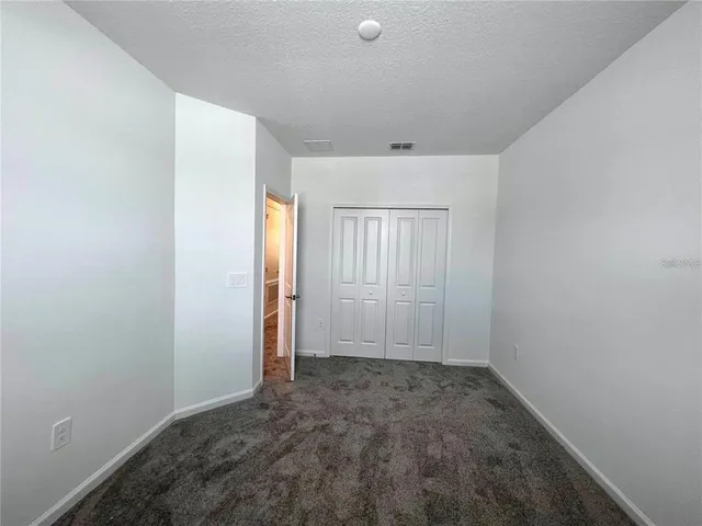 an empty room with a empty space and windows