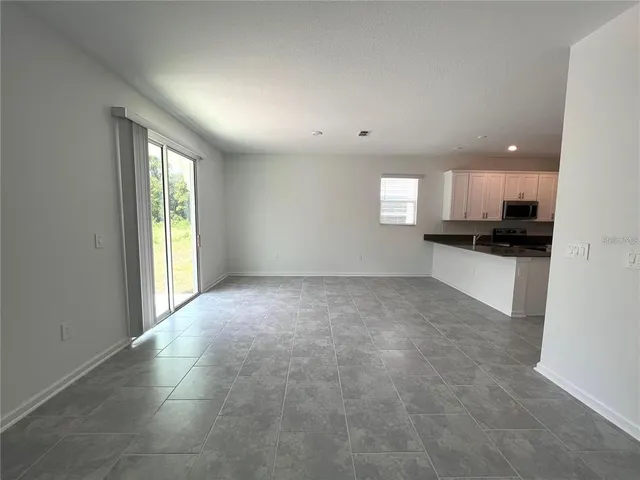 a view of a kitchen with a sink and cabinets