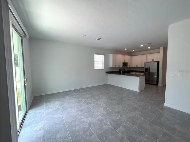 a view of a kitchen with a sink and white cabinets