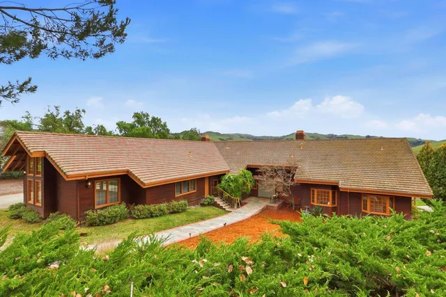 an aerial view of a house with a big yard