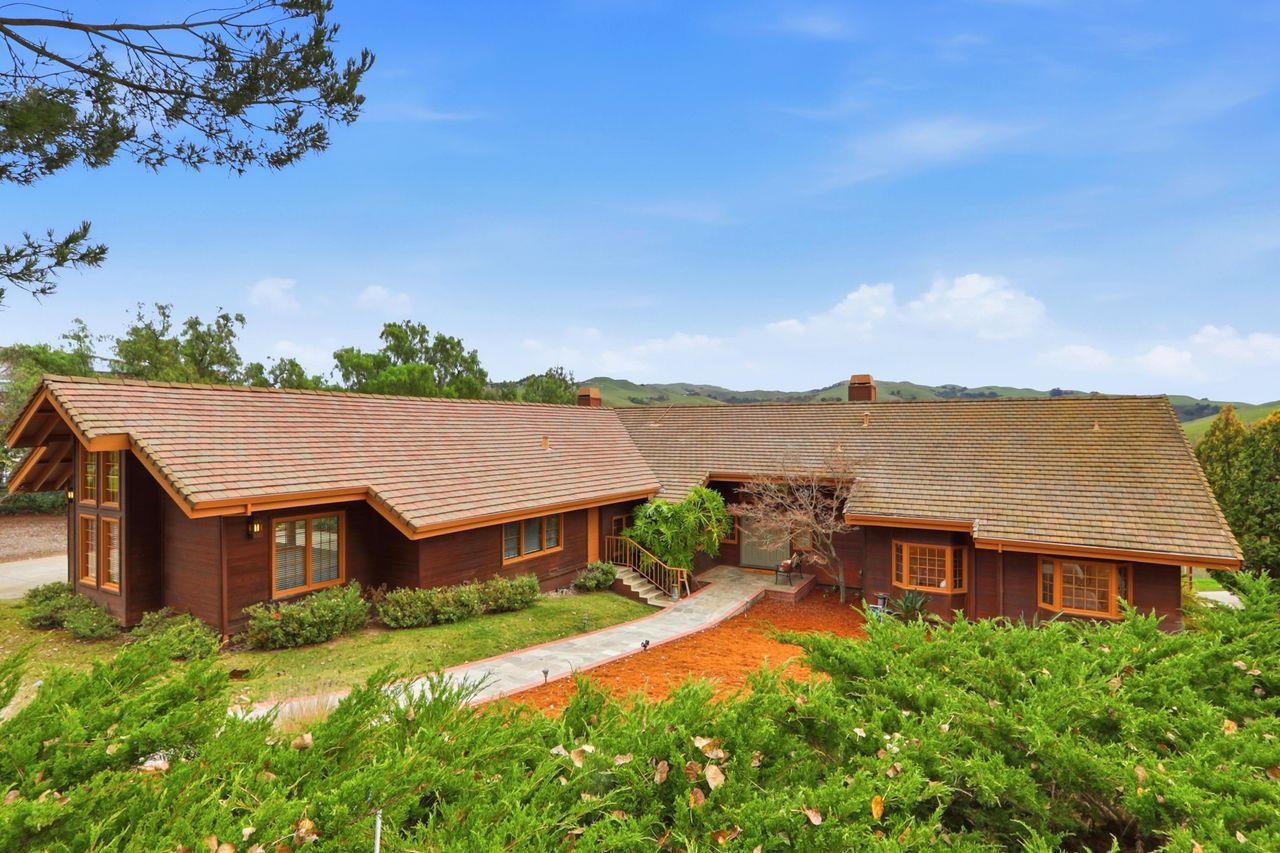 an aerial view of a house with a big yard
