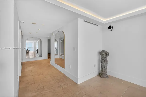 a view of a hallway with a dining table