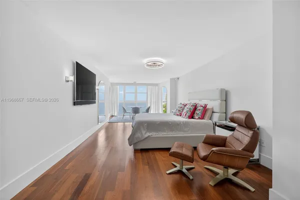 a bedroom with a large bed and a large window