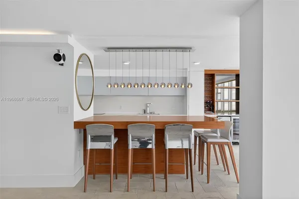 a table with chairs in front of it and cabinets