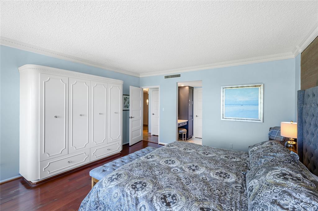 603 Longboat Club Road, Unit 1103N Longboat Key, FL 34228 - Photo 19 of 37 a bedroom with a bed and wooden floor