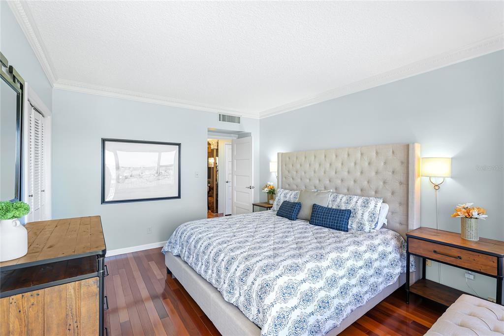 603 Longboat Club Road, Unit 1103N Longboat Key, FL 34228 - Photo 24 of 37 a bedroom with a bed and wooden floor