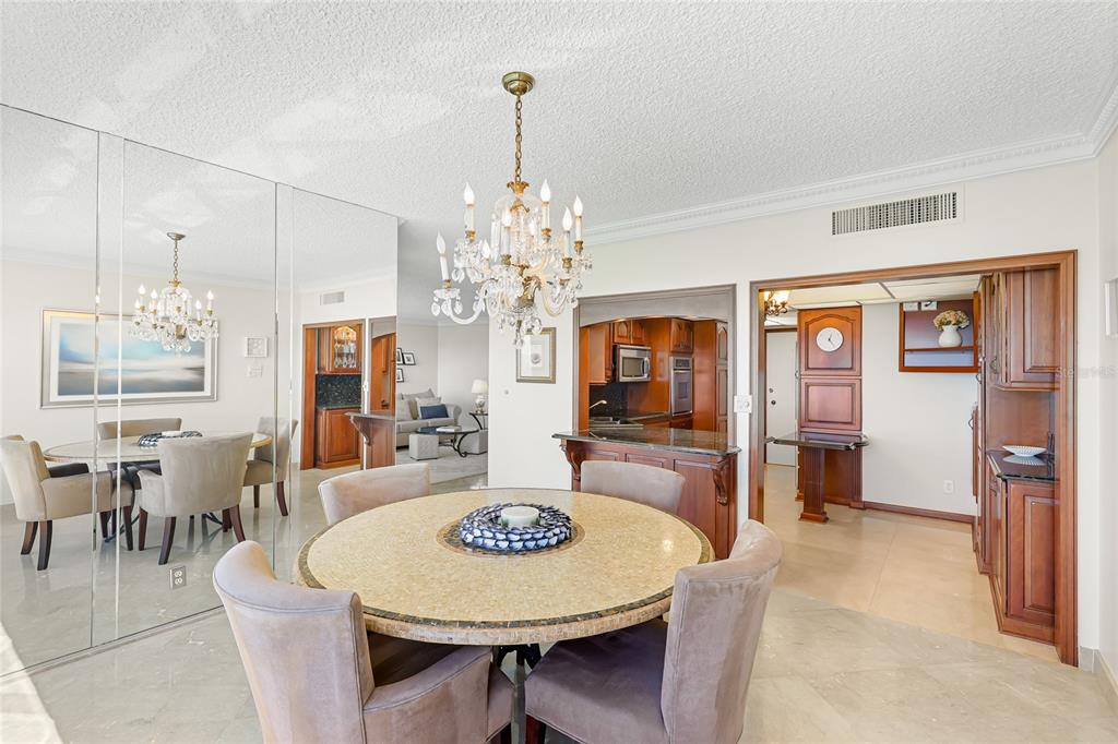 603 Longboat Club Road, Unit 1103N Longboat Key, FL 34228 - Photo 7 of 37 a view of a dining room with furniture window and wooden floor