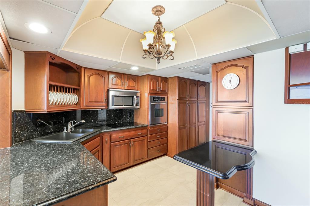 603 Longboat Club Road, Unit 1103N Longboat Key, FL 34228 - Photo 9 of 37 a kitchen with stainless steel appliances granite countertop a sink refrigerator and cabinets