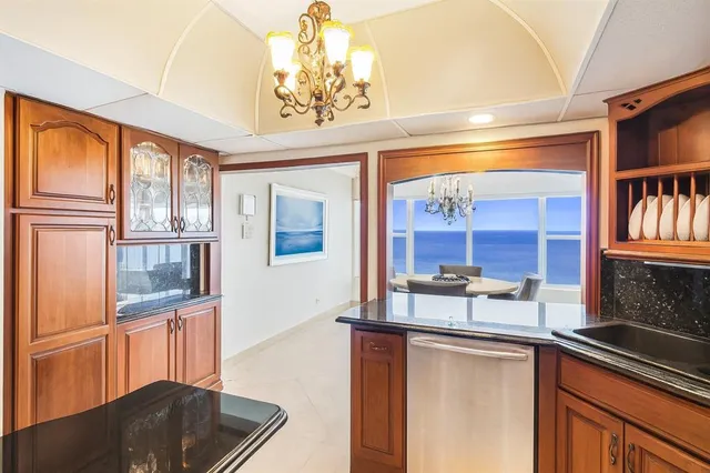 a kitchen with stainless steel appliances granite countertop a sink and cabinets