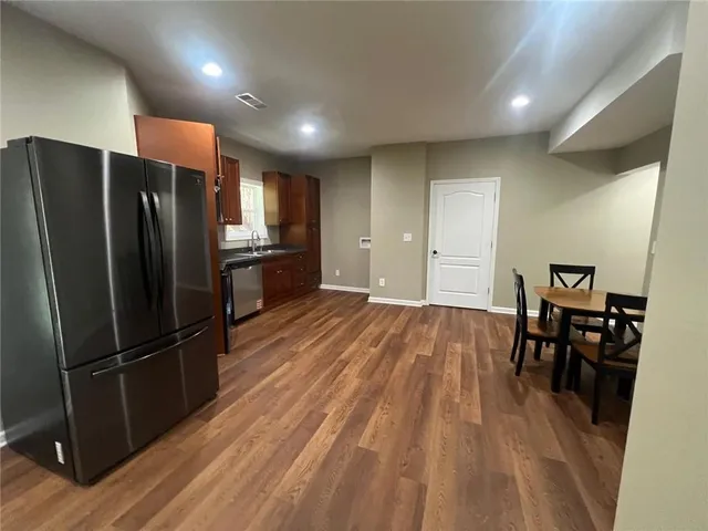 a kitchen with a refrigerator and a table