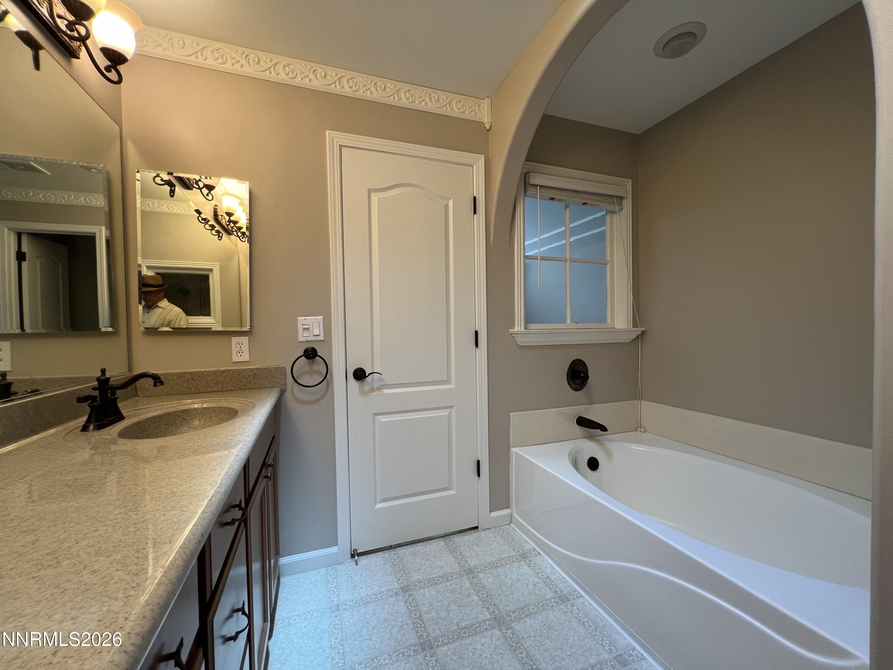 18406 Teddy Bear Court Reno, NV 89508 - Photo 17 of 44 a bathroom with a tub sink and mirror