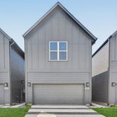 a front view of a house with garage