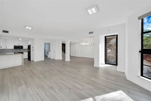 a view of a kitchen with a sink and a window