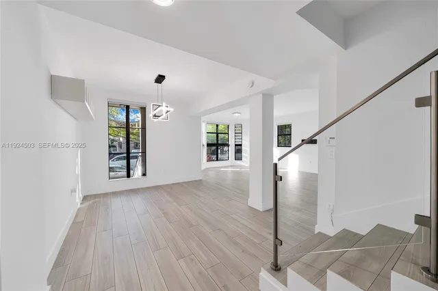 a view of an entryway with wooden floor