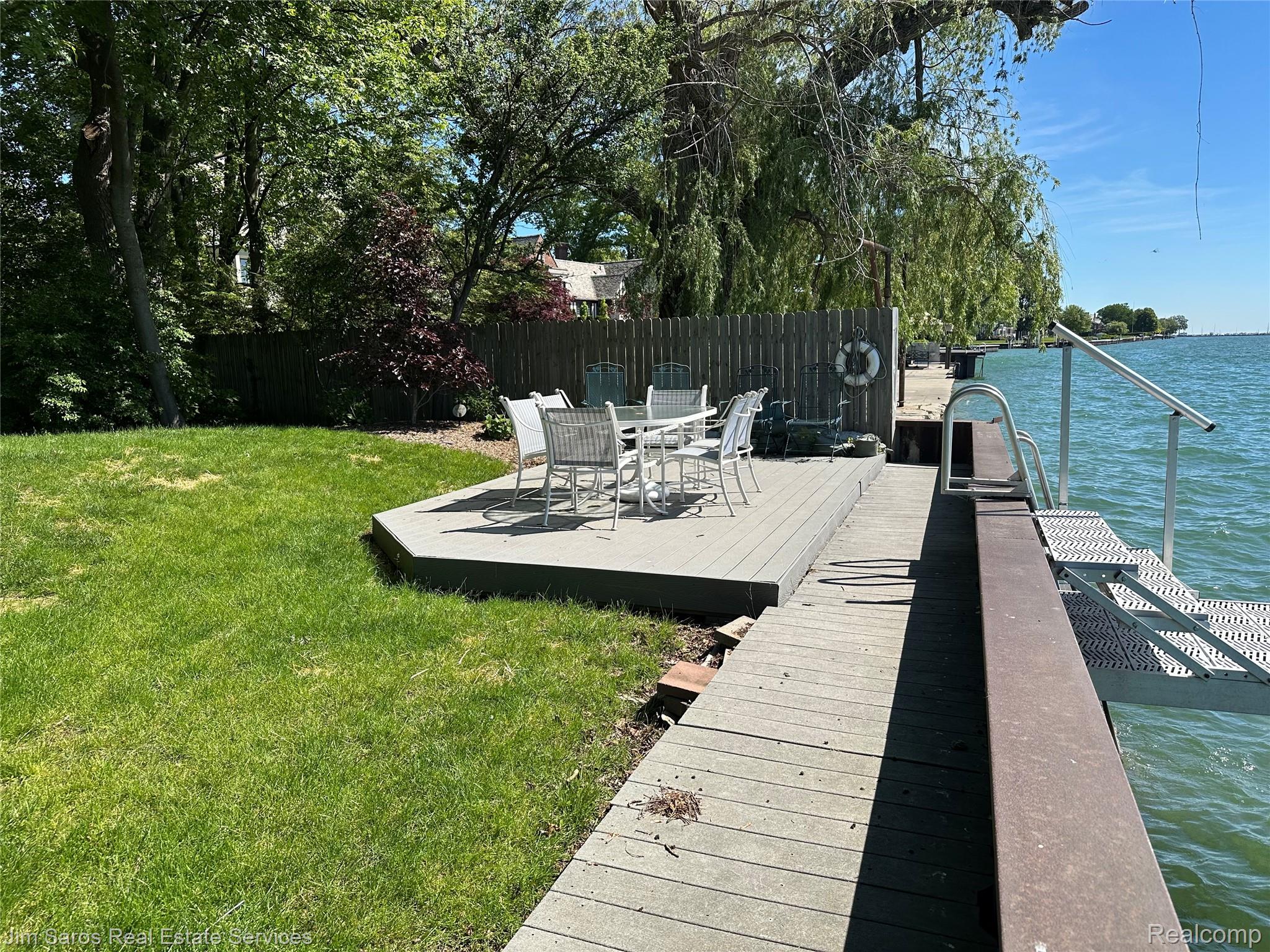 910 Edgemont Park Grosse Pointe, MI 48230 - Photo 52 of 56 Waterfront property featuring a wood dock, an adjacent composite deck patio, and a grass lawn